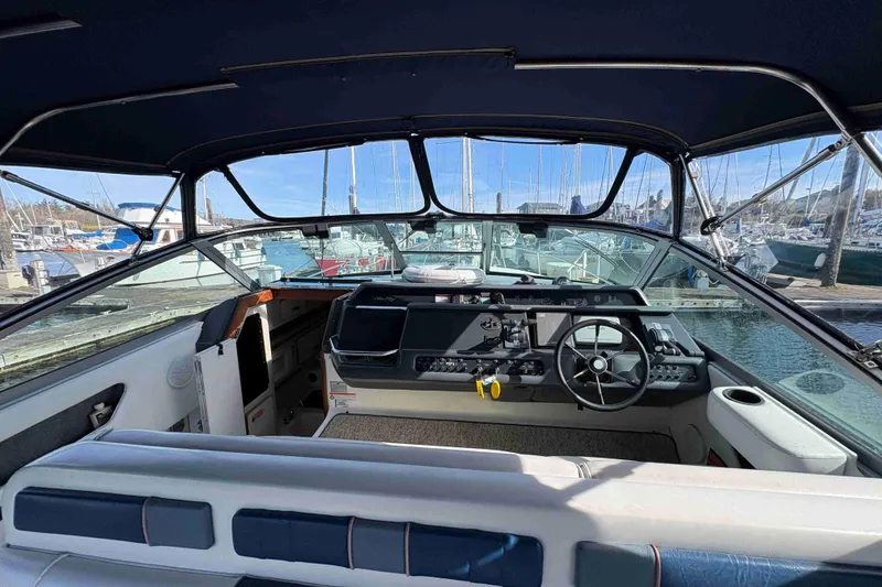 Slide: The Image of Interior view of 1993 Sea Ray Sundancer 330 boat at marina, showcasing helm and seating. - 41