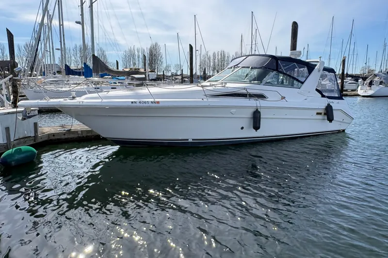 Slide: The Image of 1993 Sea Ray Sundancer 330 yacht docked in a marina, surrounded by sailboats. - 5