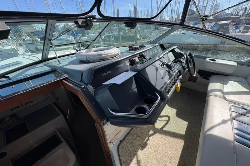 Slide: The Image of Cockpit of a 1993 Sea Ray Sundancer 330, featuring a spacious helm and seating area. - 51