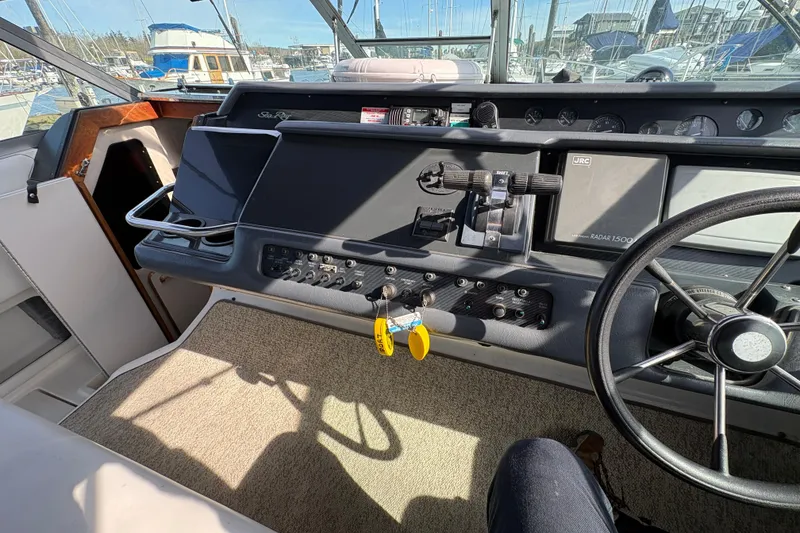 Slide: The Image of Cockpit of a 1993 Sea Ray Sundancer 330 boat with steering wheel and control panel. - 53