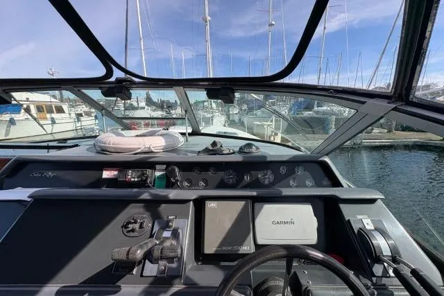 Slide: The Image of Cockpit view of a 1993 Sea Ray Sundancer 330 with Garmin navigation system at a marina. - 55