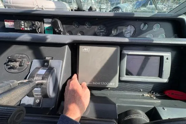 Slide: The Image of 1993 Sea Ray Sundancer 330 dashboard with radar and navigation controls. - 58