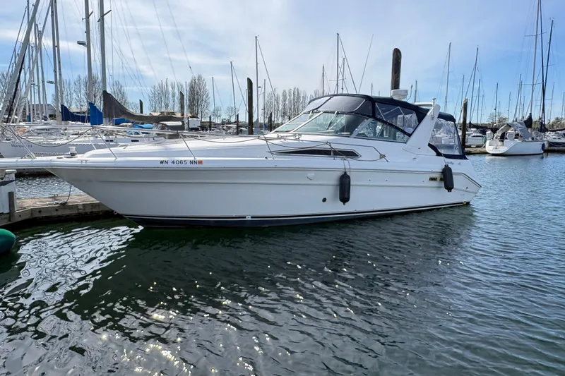 Slide: The Image of 1993 Sea Ray Sundancer 330 docked at marina, surrounded by sailboats. - 6