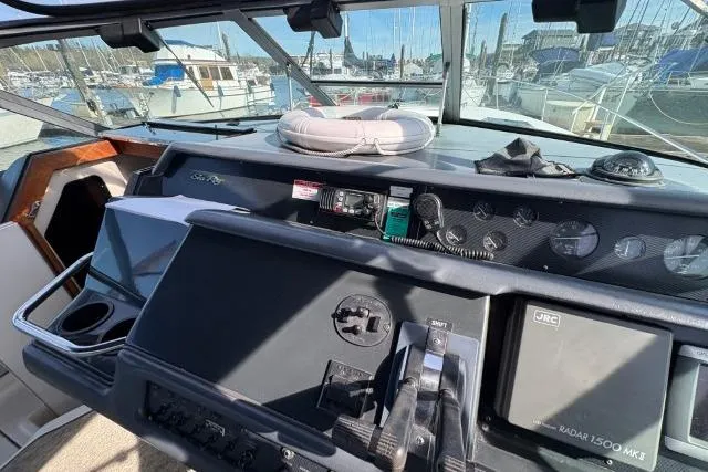 Slide: The Image of 1993 Sea Ray Sundancer 330 helm with navigation equipment and marina view. - 61
