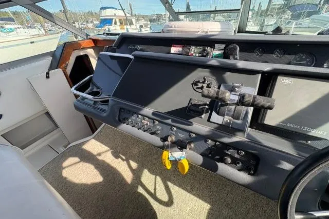 Slide: The Image of 1993 Sea Ray Sundancer 330 helm with controls and navigation equipment. - 62