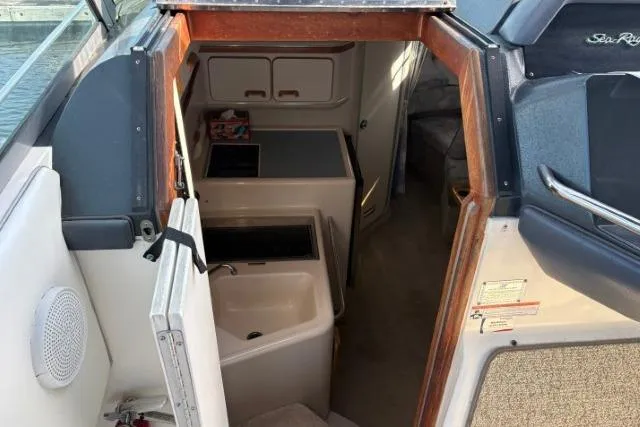 Slide: The Image of Interior view of 1993 Sea Ray Sundancer 330 boat, featuring compact kitchen and cabin area. - 64