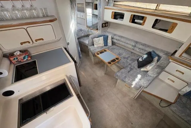 Slide: The Image of Interior of a 1993 Sea Ray Sundancer 330 yacht with kitchen and seating area. - 65