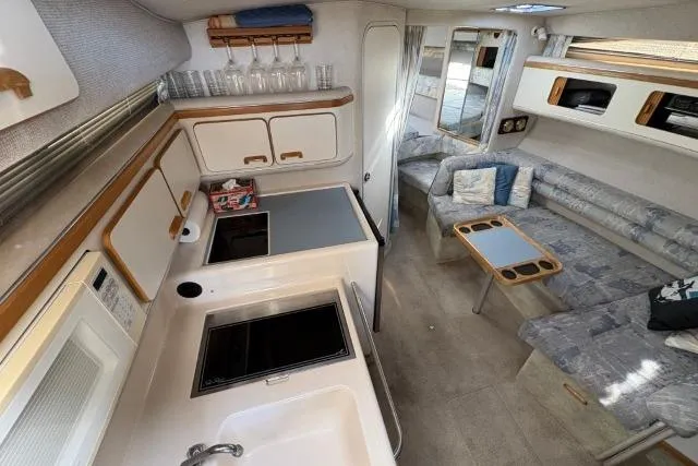 Slide: The Image of Interior of a 1993 Sea Ray Sundancer 330 yacht with kitchen and seating area. - 66
