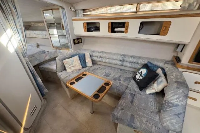 Slide: The Image of Interior of 1993 Sea Ray Sundancer 330 yacht with cozy seating and table. - 69