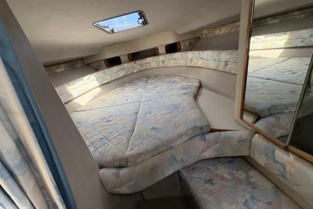 Slide: The Image of 1993 Sea Ray Sundancer 330 cabin interior with bed and mirror. - 73