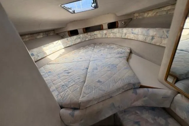 Slide: The Image of Interior cabin of 1993 Sea Ray Sundancer 330 with a cozy bed and skylight. - 74