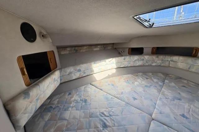 Slide: The Image of Interior cabin of 1993 Sea Ray Sundancer 330 with cushioned seating and overhead hatch. - 76