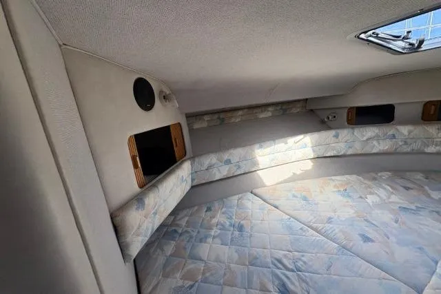 Slide: The Image of Interior cabin of 1993 Sea Ray Sundancer 330 with cushioned seating and storage compartments. - 77