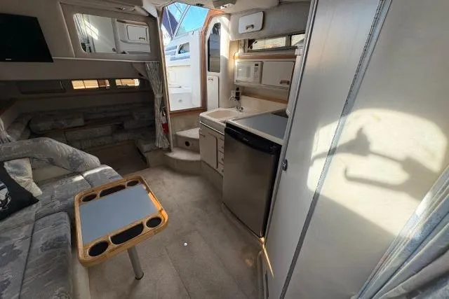 Slide: The Image of Interior of 1993 Sea Ray Sundancer 330 yacht, featuring kitchenette and seating area. - 78