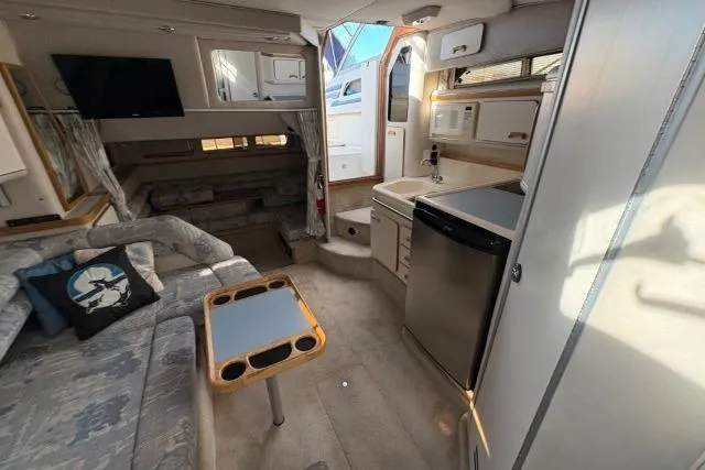 Slide: The Image of Interior of a 1993 Sea Ray Sundancer 330 yacht with kitchenette and seating area. - 79