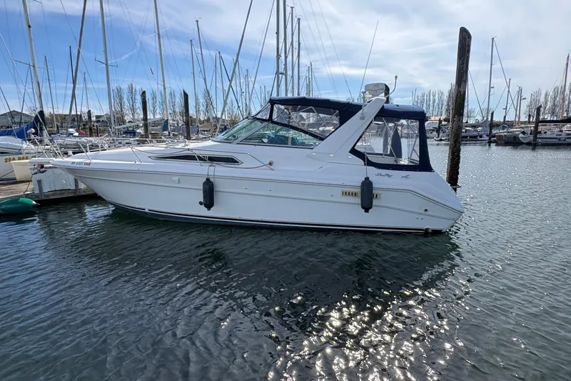 Slide: The Image of 1993 Sea Ray Sundancer 330 yacht docked at marina, surrounded by sailboats. - 8