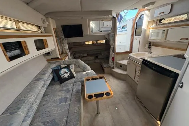 Slide: The Image of Interior of a 1993 Sea Ray Sundancer 330 yacht with cozy seating and modern amenities. - 80