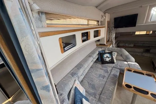 Slide: The Image of Interior of 1993 Sea Ray Sundancer 330 yacht with cozy seating and modern amenities. - 82