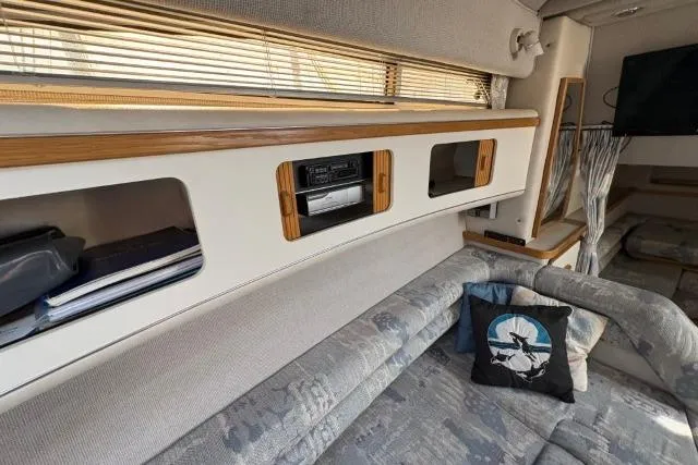 Slide: The Image of Interior of 1993 Sea Ray Sundancer 330 with cozy seating and built-in storage. - 83