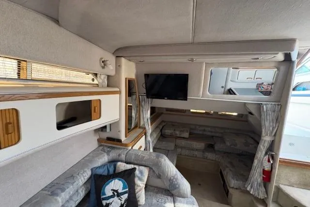 Slide: The Image of Interior of 1993 Sea Ray Sundancer 330 yacht with cozy seating and TV. - 84