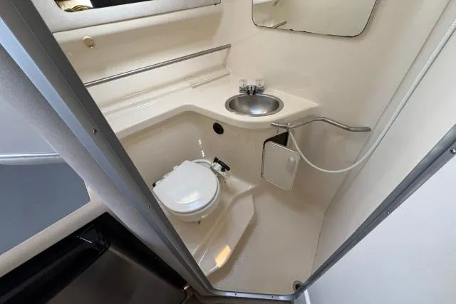 Slide: The Image of 1993 Sea Ray Sundancer 330 bathroom with toilet, sink, and mirror. - 85