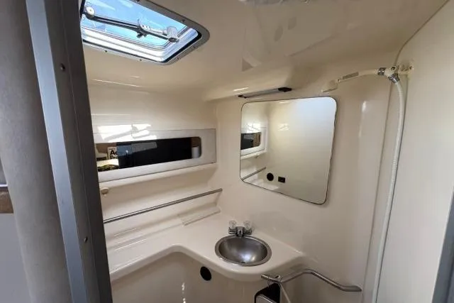 Slide: The Image of 1993 Sea Ray Sundancer 330 bathroom with sink, mirror, and skylight. - 88