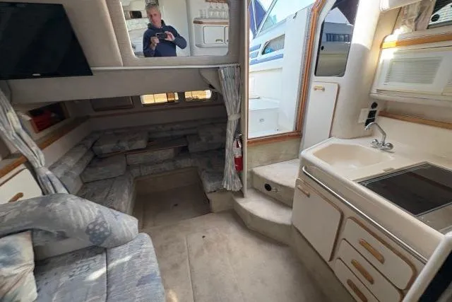 Slide: The Image of Interior of a 1993 Sea Ray Sundancer 330 yacht with seating and kitchenette. - 91