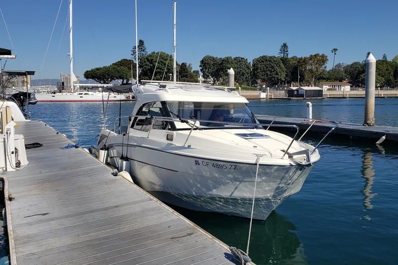 The Image of 2019 Beneteau Antares 23 docked at a marina under clear blue skies. - 0