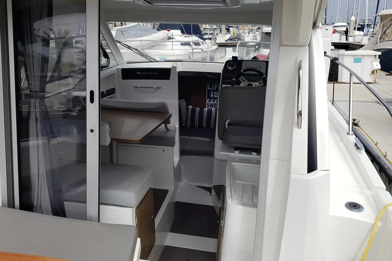 Slide: The Image of Interior view of a 2019 Beneteau Antares 23 boat at a marina. - 14