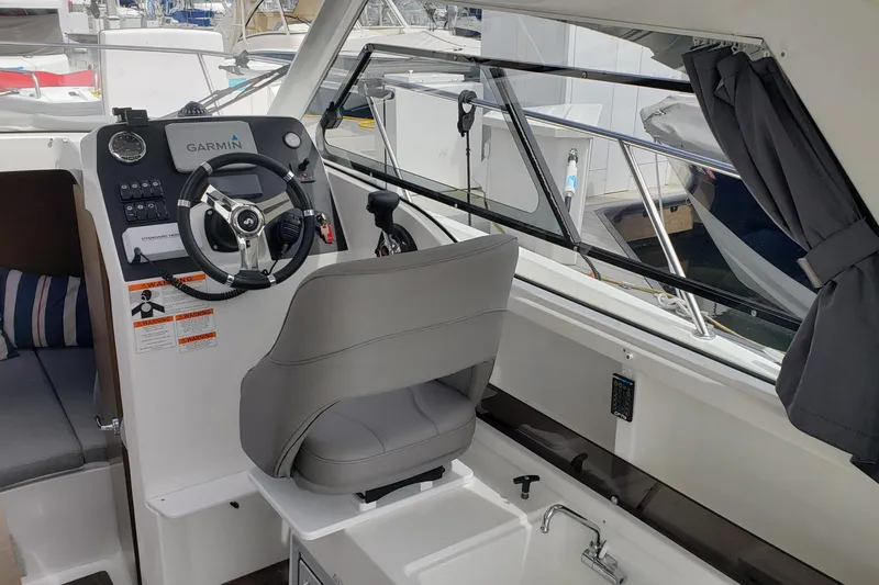 Slide: The Image of Interior cockpit of 2019 Beneteau Antares 23 with Garmin navigation system and comfortable seating. - 16