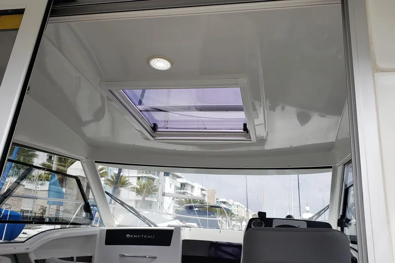 Slide: The Image of Interior view of 2019 Beneteau Antares 23 boat with skylight and modern design. - 17