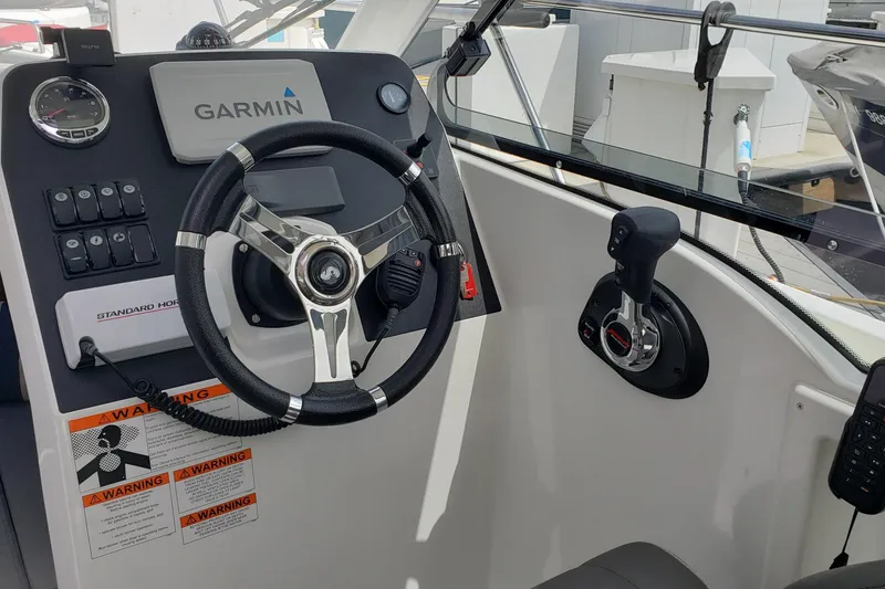 Slide: The Image of Cockpit of 2019 Beneteau Antares 23 with Garmin navigation system and steering wheel. - 20