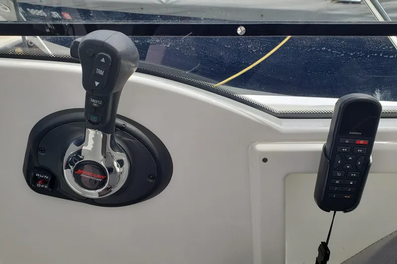 Slide: The Image of Control panel of a 2019 Beneteau Antares 23 boat with throttle and Garmin device. - 21