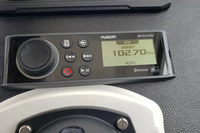Slide: The Image of Fusion MS-RA70N marine stereo displaying FM 102.70 MHz on a 2019 Beneteau Antares 23. - 26