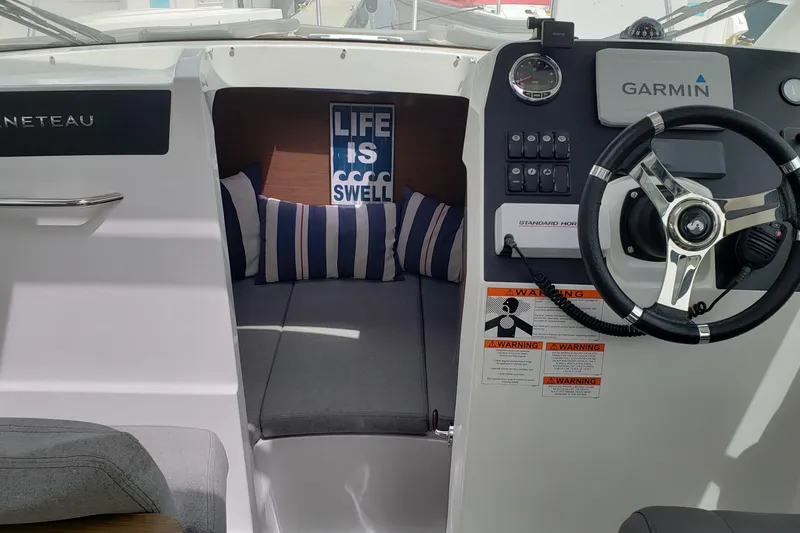 Slide: The Image of Interior of 2019 Beneteau Antares 23 boat with steering wheel and cozy cabin. - 28