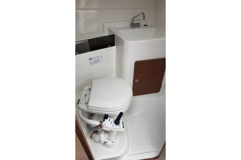 Slide: The Image of Compact bathroom in 2019 Beneteau Antares 23 boat with toilet and sink. - 34