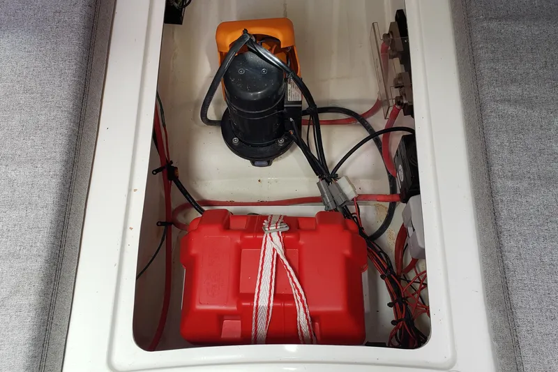 Slide: The Image of Electrical compartment of a 2019 Beneteau Antares 23 boat with battery and wiring. - 39