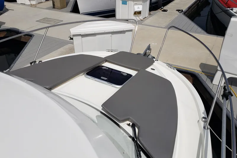 Slide: The Image of 2019 Beneteau Antares 23 boat deck with sun pads at marina. - 4