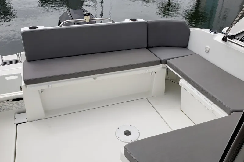 Slide: The Image of Spacious seating area on a 2019 Beneteau Antares 23 boat, featuring gray cushions. - 41