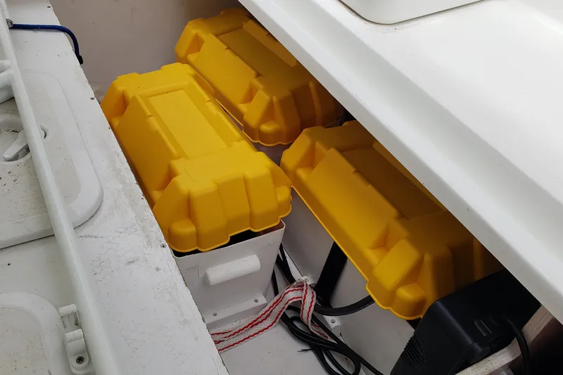 Slide: The Image of Yellow battery boxes in a 2019 Beneteau Antares 23 boat compartment. - 43