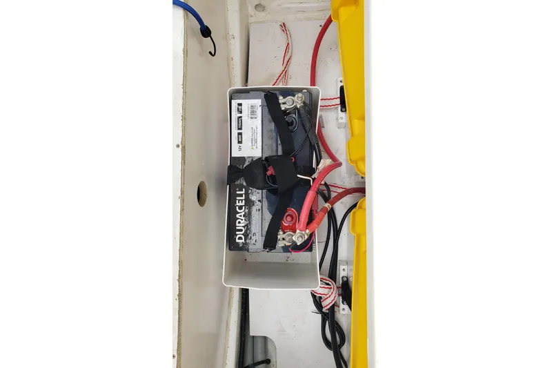 Slide: The Image of Battery compartment of 2019 Beneteau Antares 23 with Duracell battery and wiring. - 44