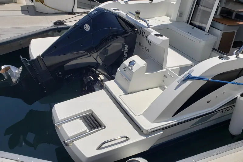 Slide: The Image of 2019 Beneteau Antares 23 boat docked, featuring a powerful Mercury outboard engine. - 47