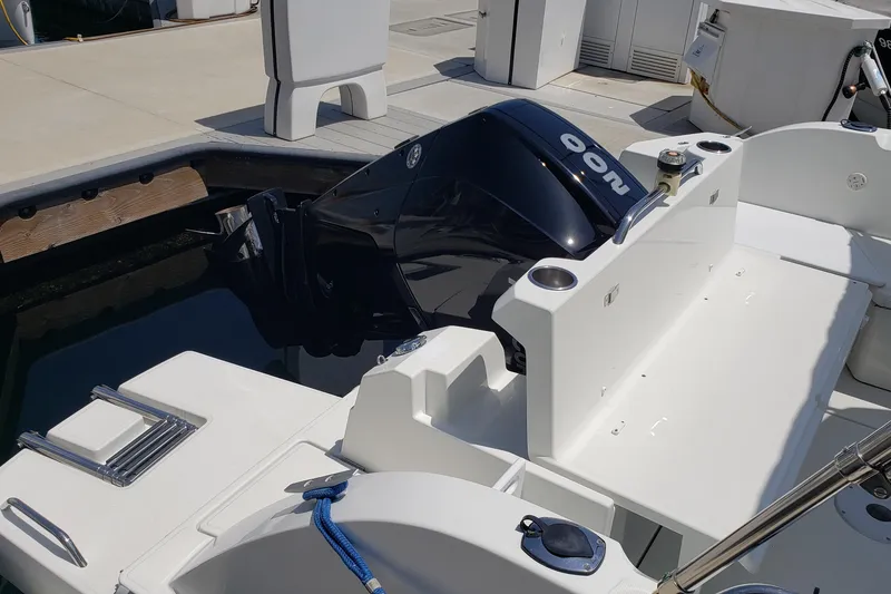 Slide: The Image of 2019 Beneteau Antares 23 boat with outboard motor at dockside. - 48