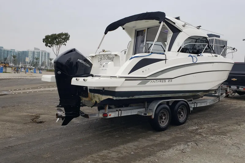 Slide: The Image of 2019 Beneteau Antares 23 boat on trailer with Mercury engine at marina. - 54