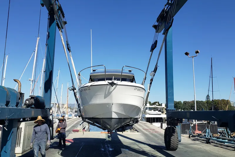 Slide: The Image of 2019 Beneteau Antares 23 boat lifted at marina with blue sky background. - 60