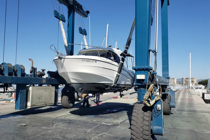 Slide: The Image of 2019 Beneteau Antares 23 boat being lifted at a marina. - 61