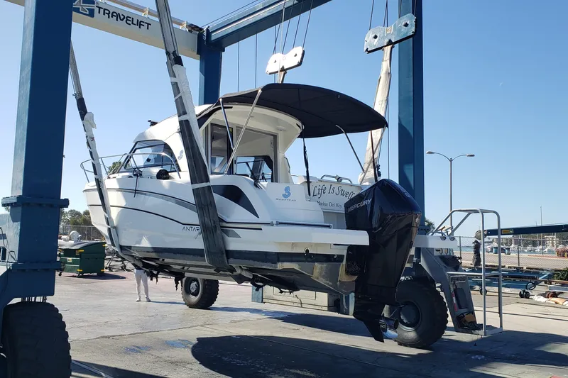 Slide: The Image of 2019 Beneteau Antares 23 boat on a travel lift at a marina. - 62