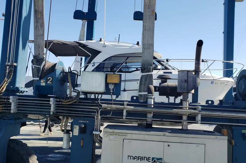 Slide: The Image of 2019 Beneteau Antares 23 boat on a lift at a marina. - 65