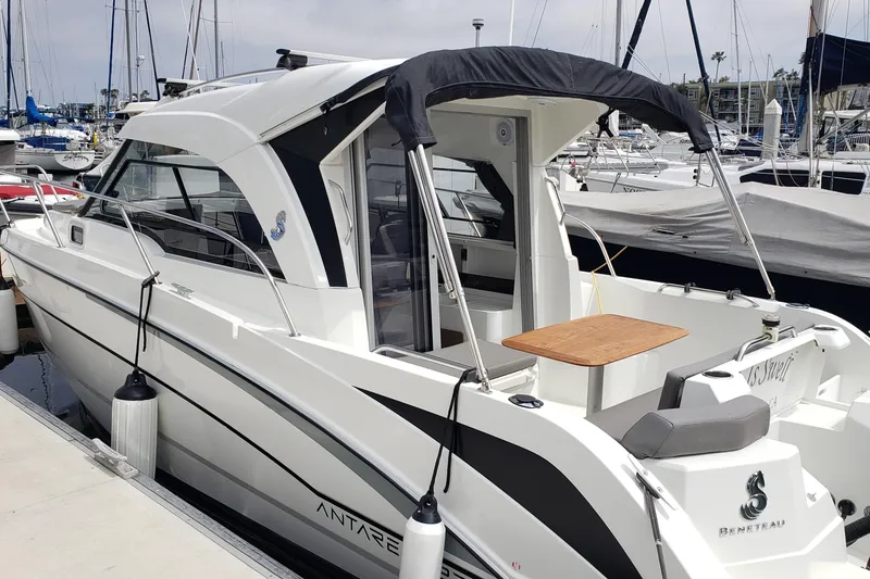 Slide: The Image of 2019 Beneteau Antares 23 docked at marina, featuring sleek design and outdoor seating. - 9