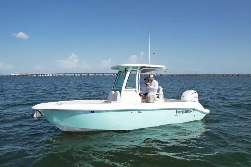 The Image of 2022 Everglades 235 Center Console boat on open water under clear blue sky. - 1
